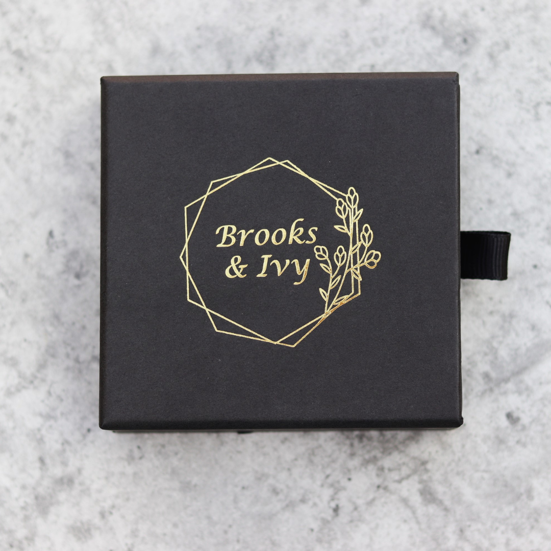 Brooks & Ivy black gift box packaging with gold logo.