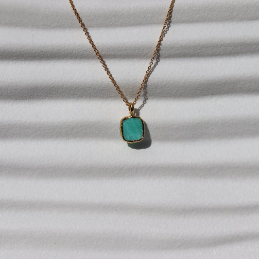 Photo of amazonite blue stone gold plated necklace on a white background.